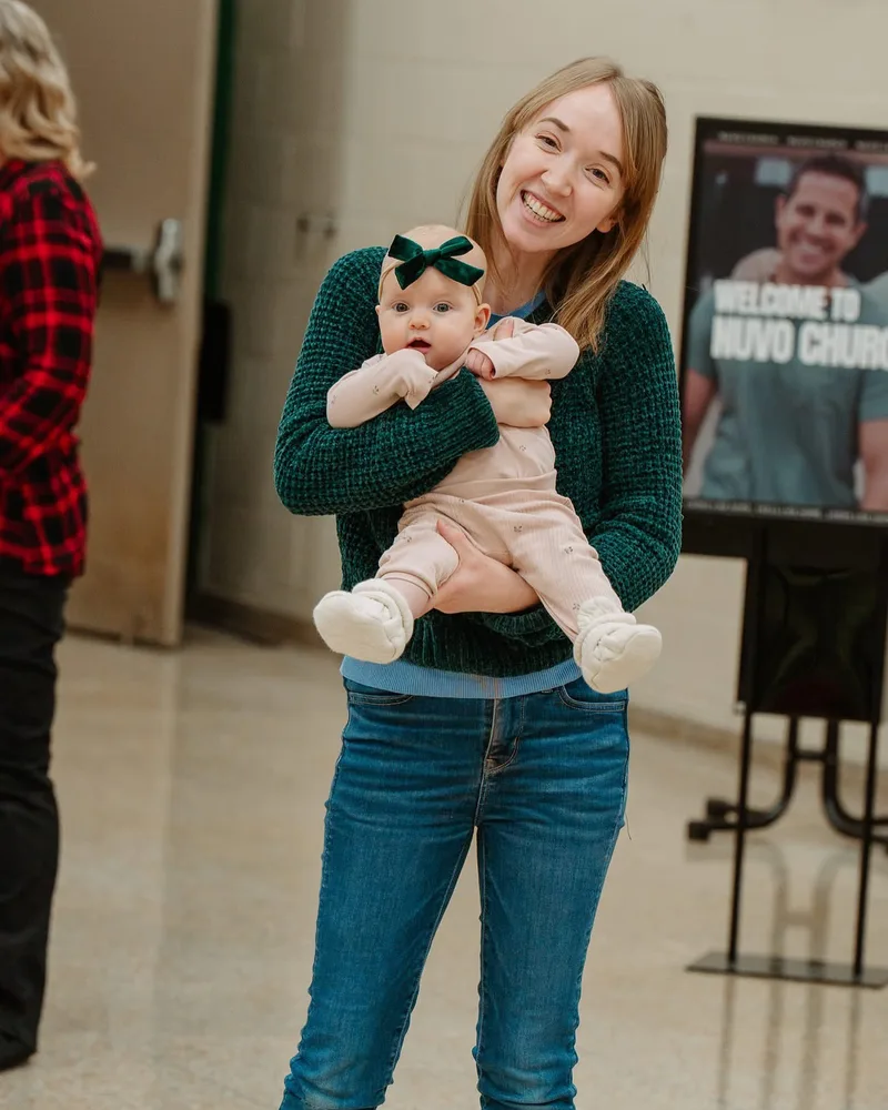 Mom holding her baby girl on a Sunday at Nuvo Church in Dublin, Ohio