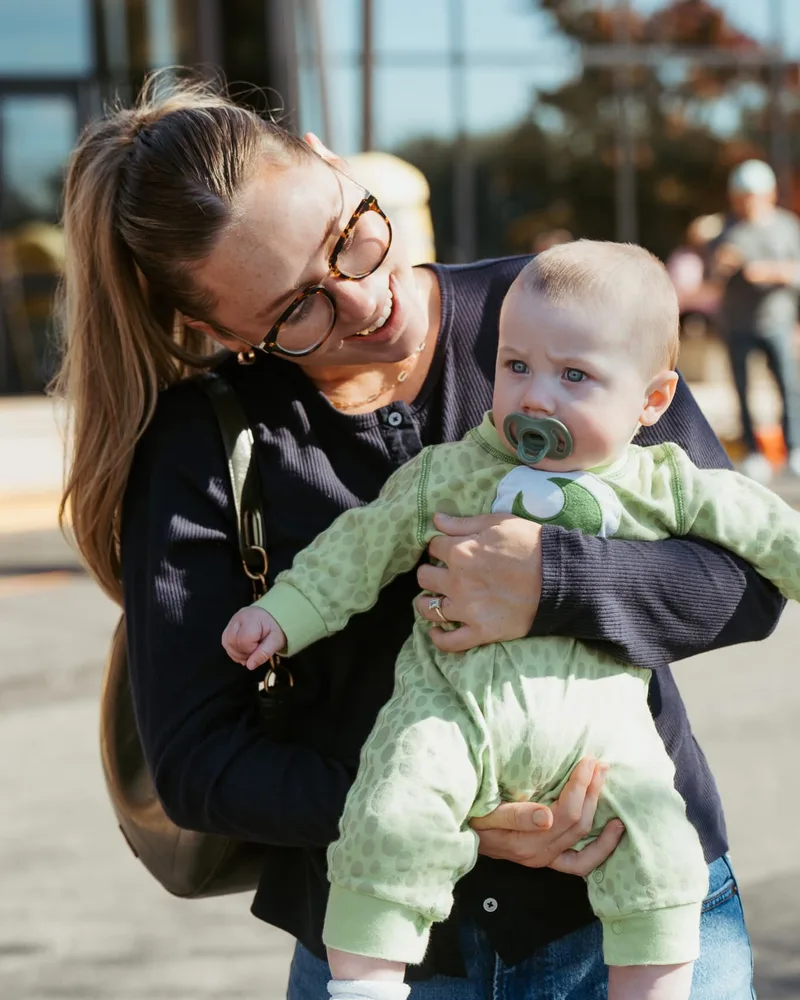 Smiling mom holding her baby at Nuvo Church in Dublin, Ohio