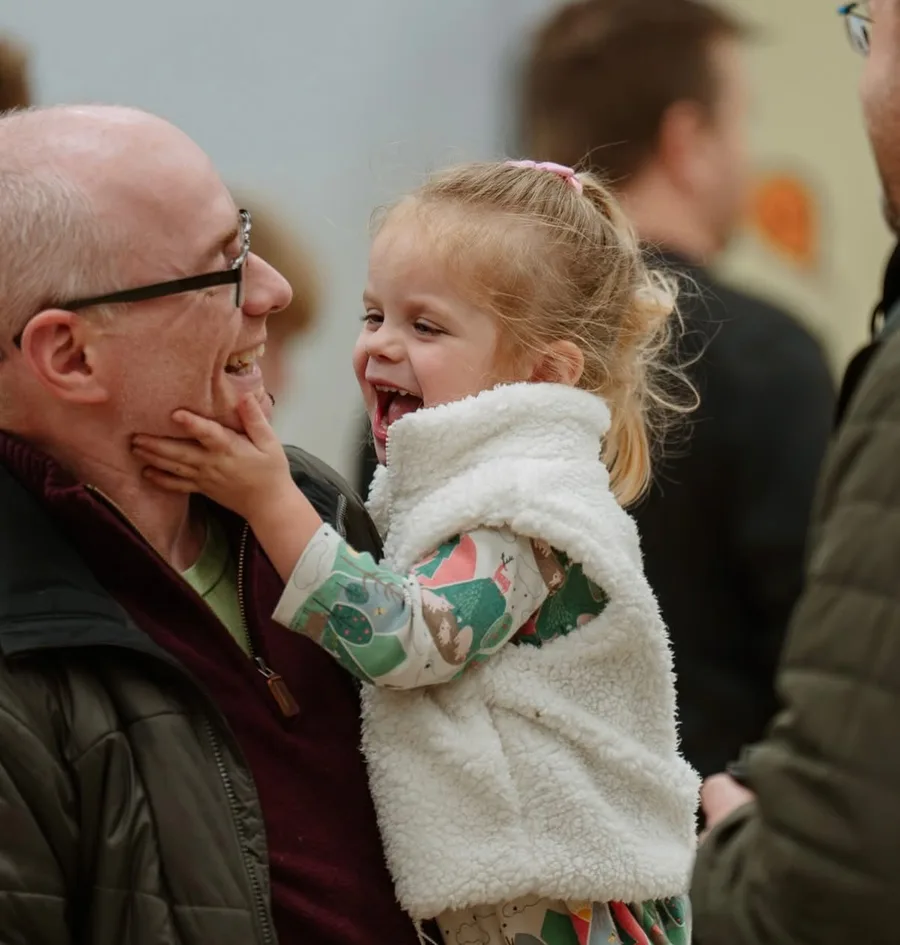 Dad laughing with his young daughter at Nuvo Church in Dublin, Ohio