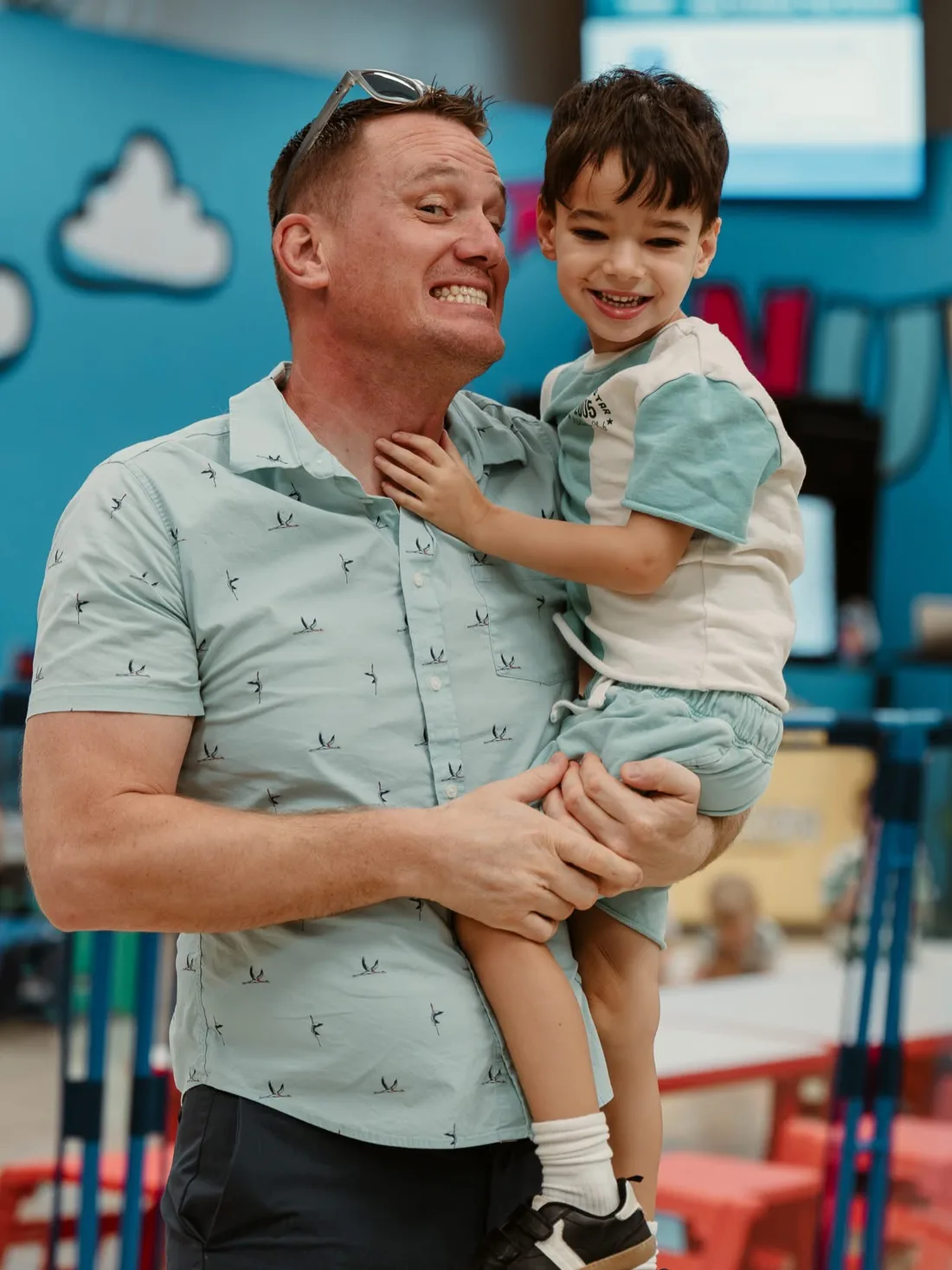 Dad holding his smiling son at Nuvo Kids in Dublin, Ohio