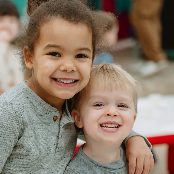 Brother and sister smiling together at Nuvo Kids in Dublin, Ohio