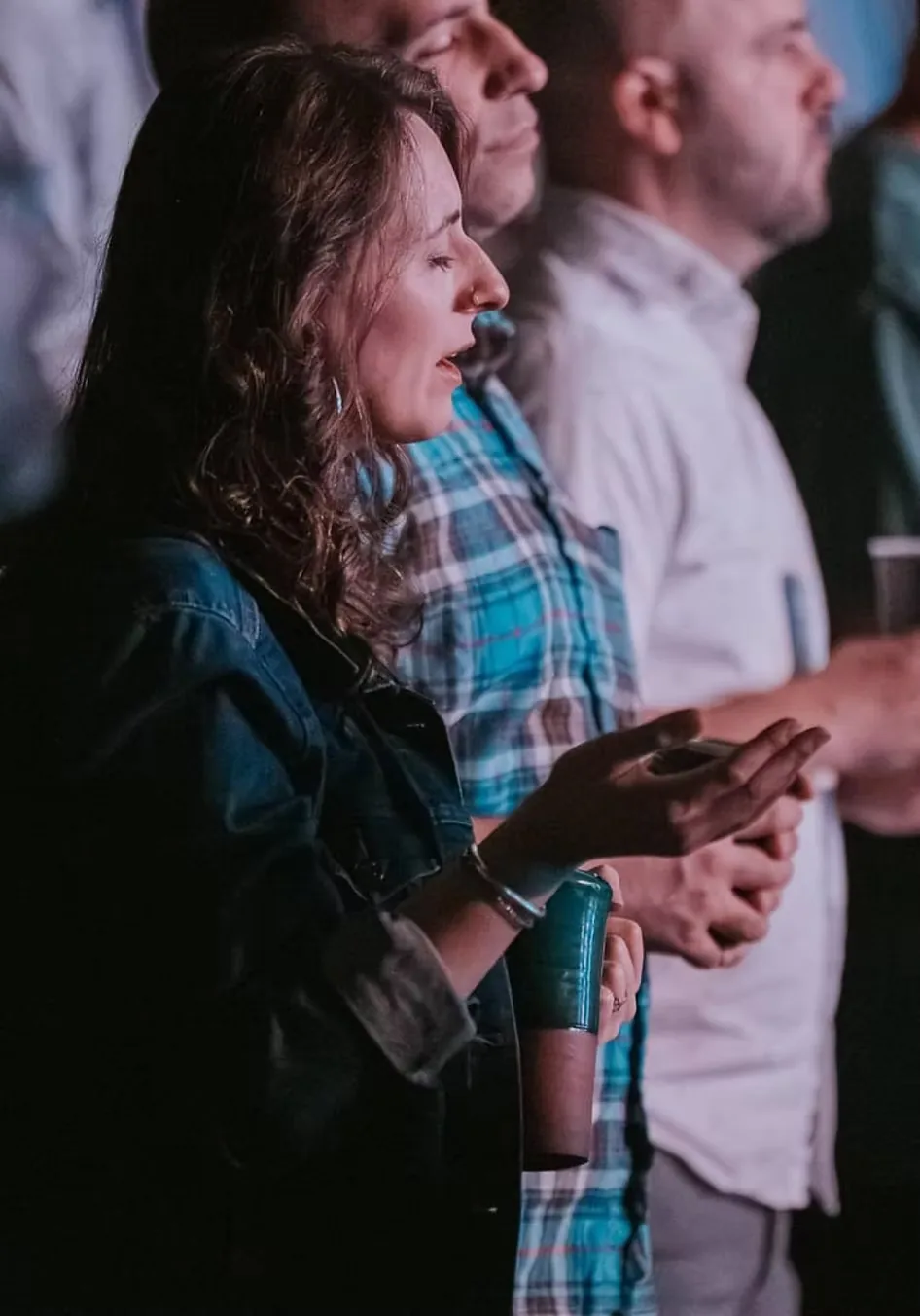 Woman worshiping with open hands during a Sunday service at Nuvo Church in Dublin, Ohio