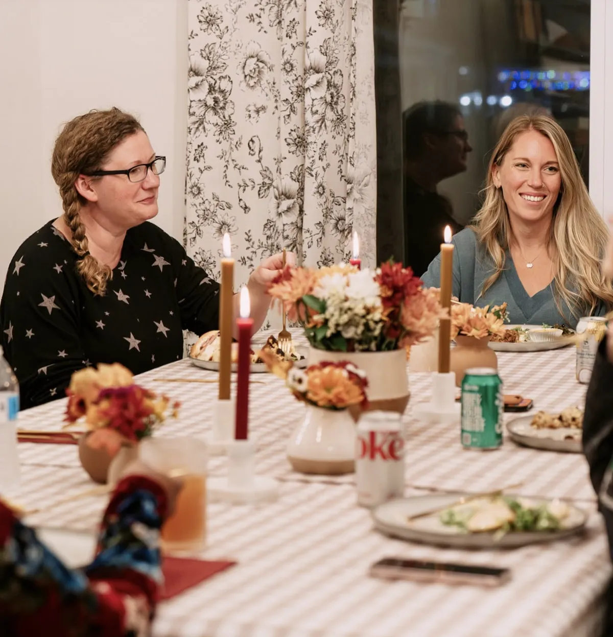 Friends gathered around a candlelit table at a Nuvo Church dinner party in Columbus, Ohio