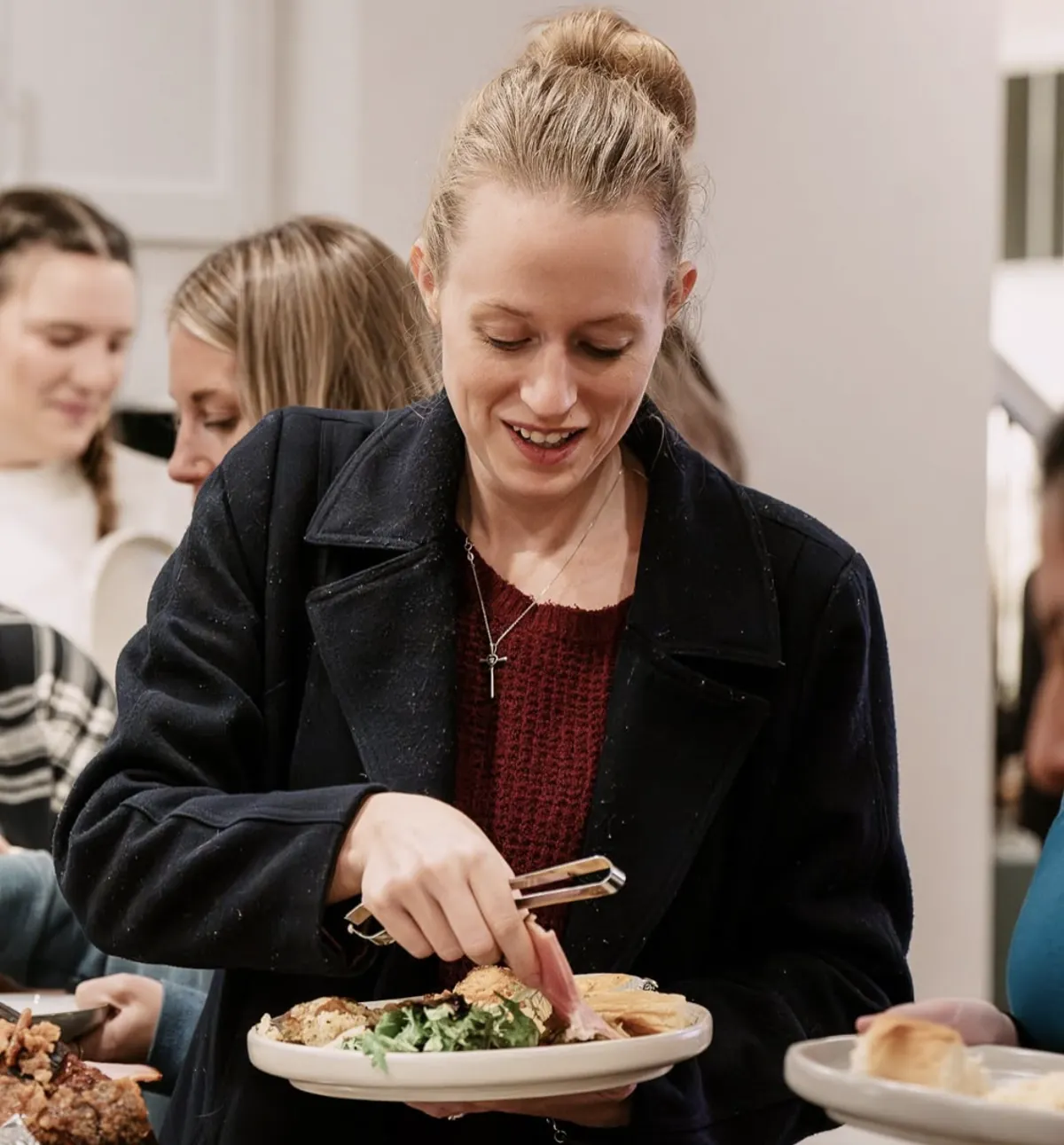 Woman serving herself dinner at a Nuvo Church dinner party in Dublin, Ohio