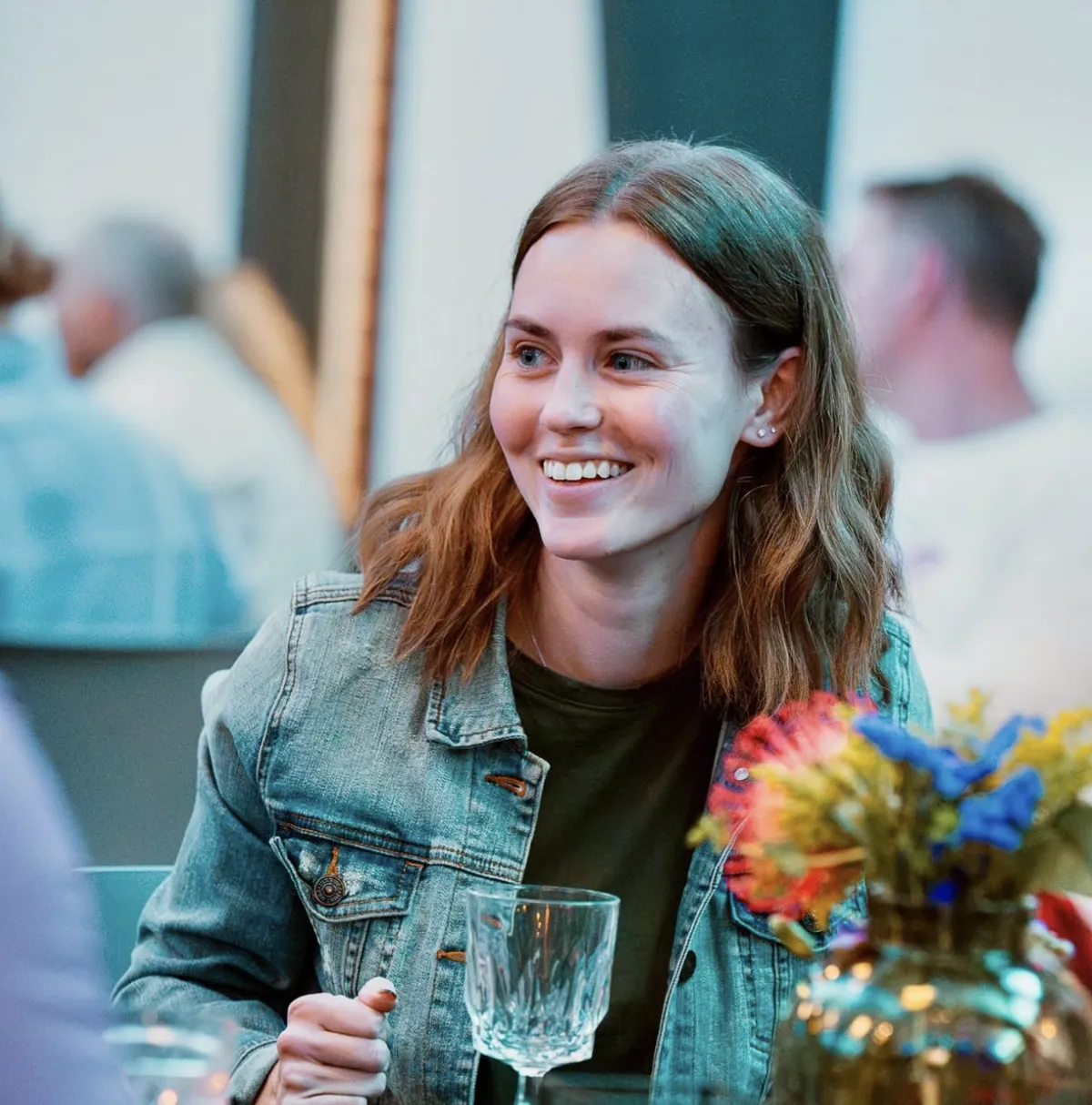 Woman smiling at a Nuvo Church dinner party in Columbus