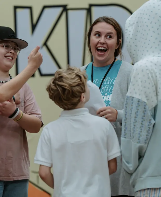 Excited Nuvo Kids leader with elementary kids at church in Columbus, Ohio