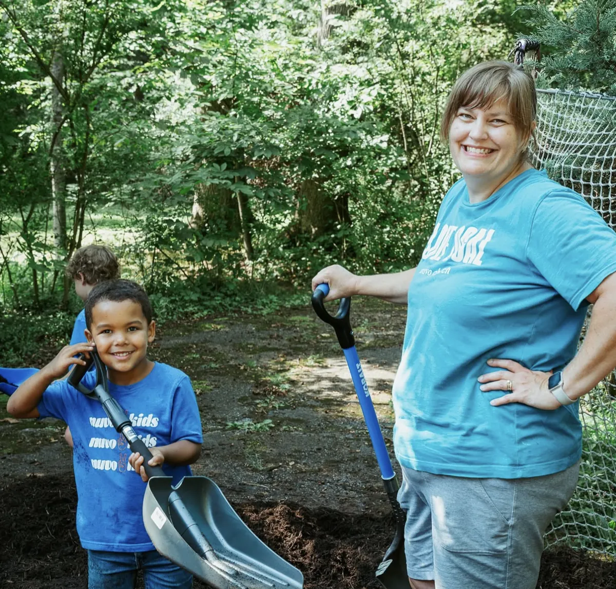 Mom and son with shovels serving together at a Nuvo Church Love Local project in Dublin, Ohio