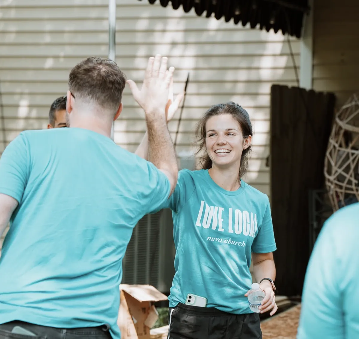 Love Local volunteers high-fiving at a Nuvo Church serve day in Dublin, Ohio