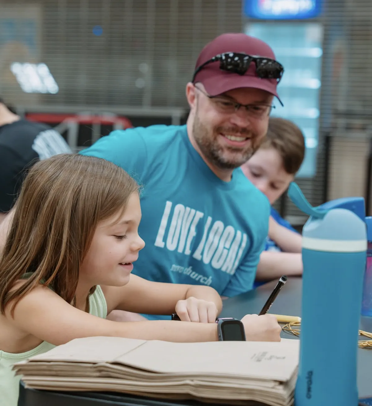 Love Local volunteer helping kids with a project at Nuvo Church in Columbus, Ohio
