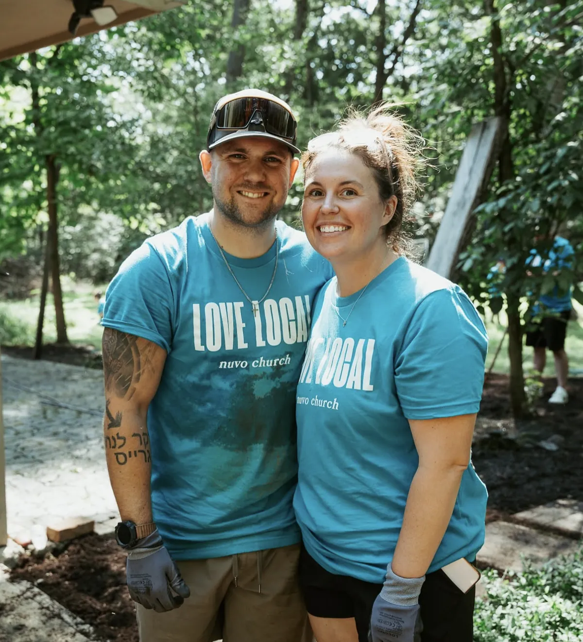 Couple in Love Local shirts smiling after a day of serving with Nuvo Church in Columbus, Ohio