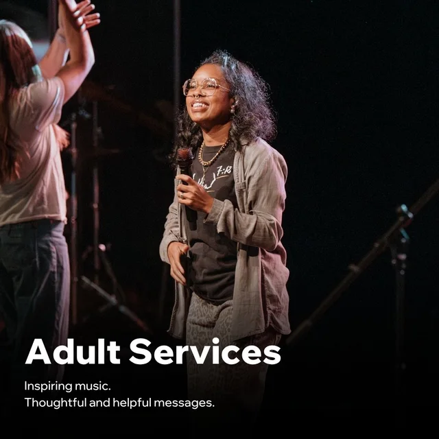 Smiling worship leader with a microphone on stage during an adult worship service at Nuvo Church in Dublin, Ohio