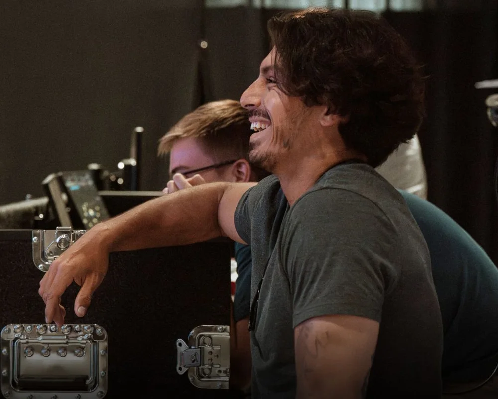Production team volunteer laughing at the sound booth during a Sunday service at Nuvo Church in Dublin and Columbus, Ohio