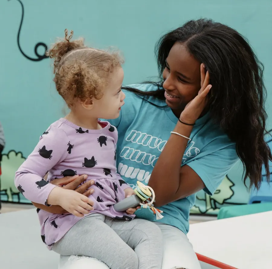 Nuvo Kids volunteer smiling with a toddler at Nuvo Church in Dublin, Ohio