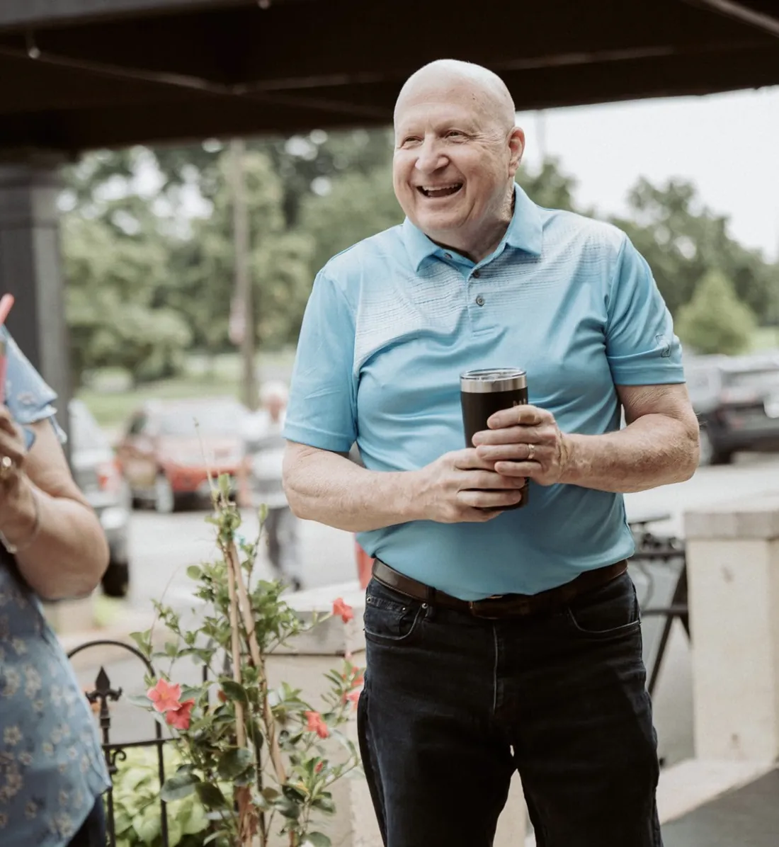 Smiling Nuvo Church volunteer serving with a coffee in hand in Dublin, Ohio