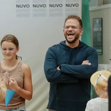 Dad laughing with his daughter at a Nuvo Church family event
