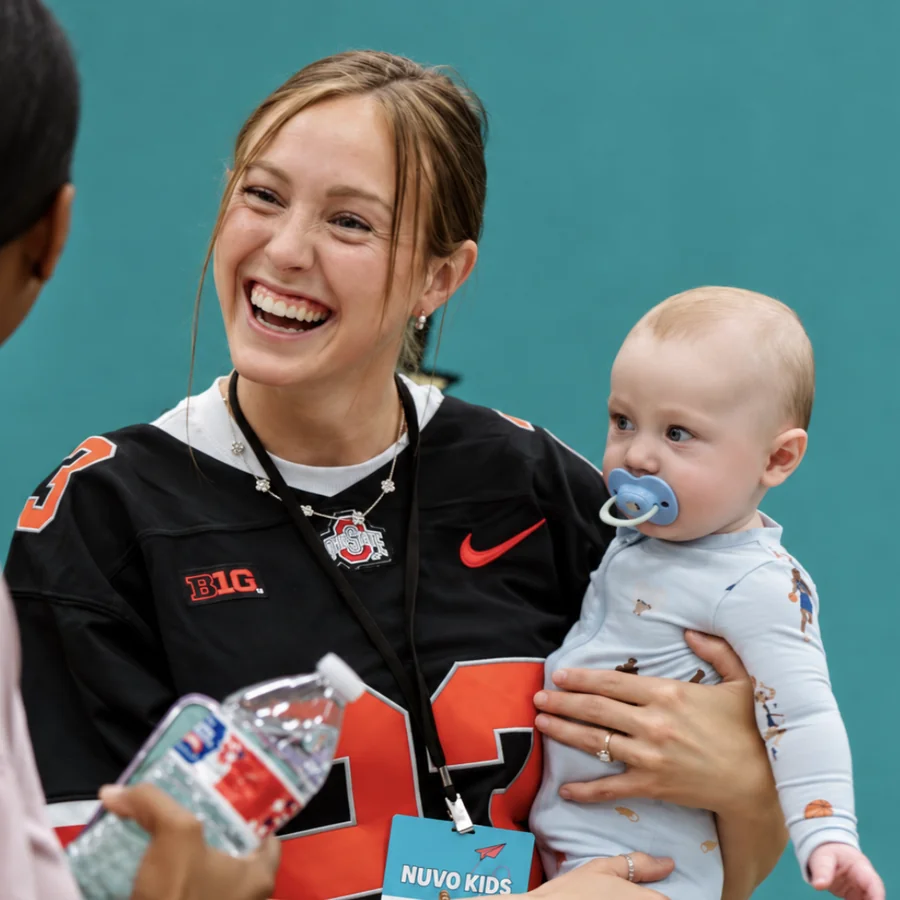 Kloe Ellis, Nuvo Kids Sunday Lead, holding a baby at Nuvo Church in Dublin, Ohio