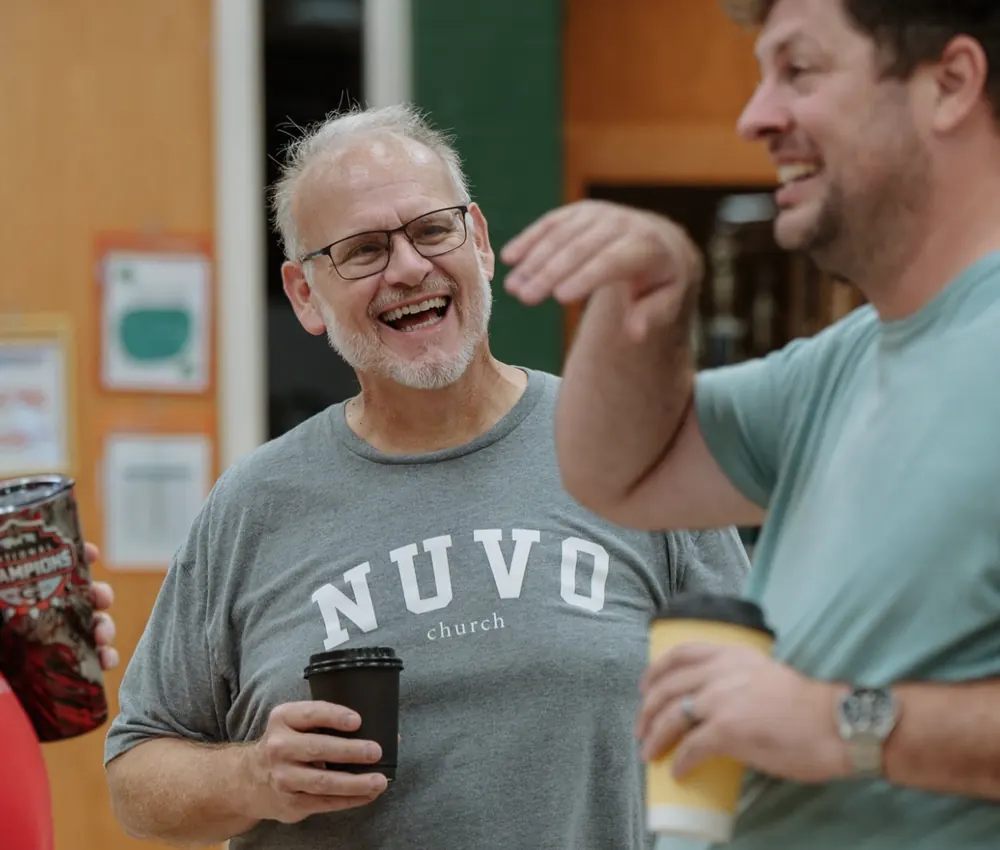 Friends laughing over coffee at Nuvo Church in Columbus, Ohio