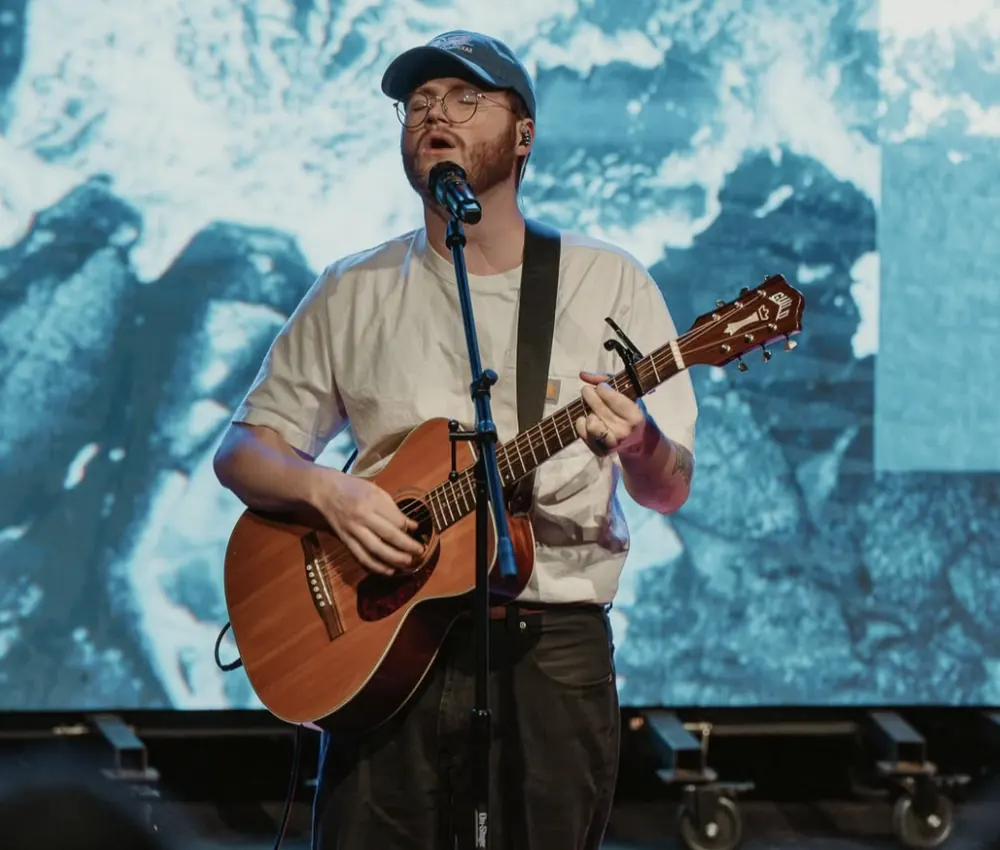 Worship leader playing acoustic guitar at Nuvo Church in Columbus, Ohio