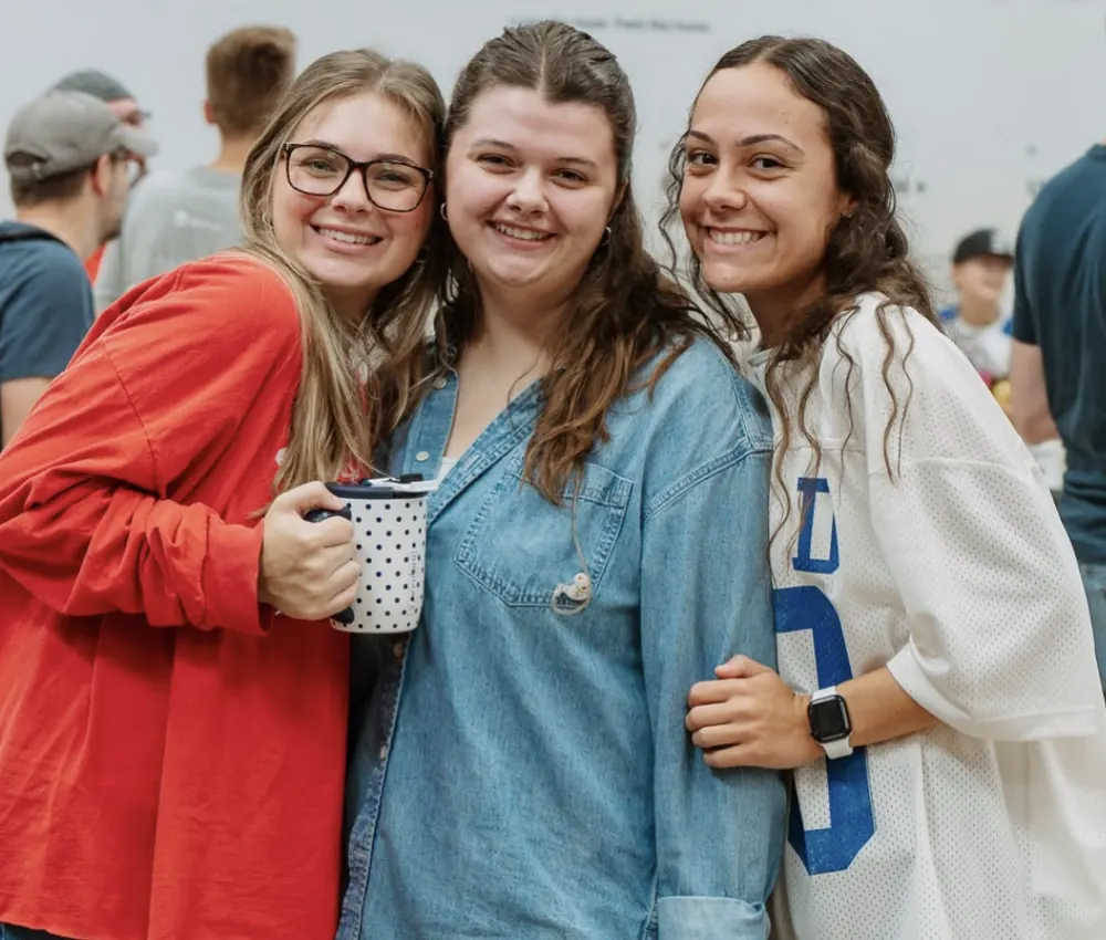 Friends smiling together on Sunday at Nuvo Church in Columbus, Ohio