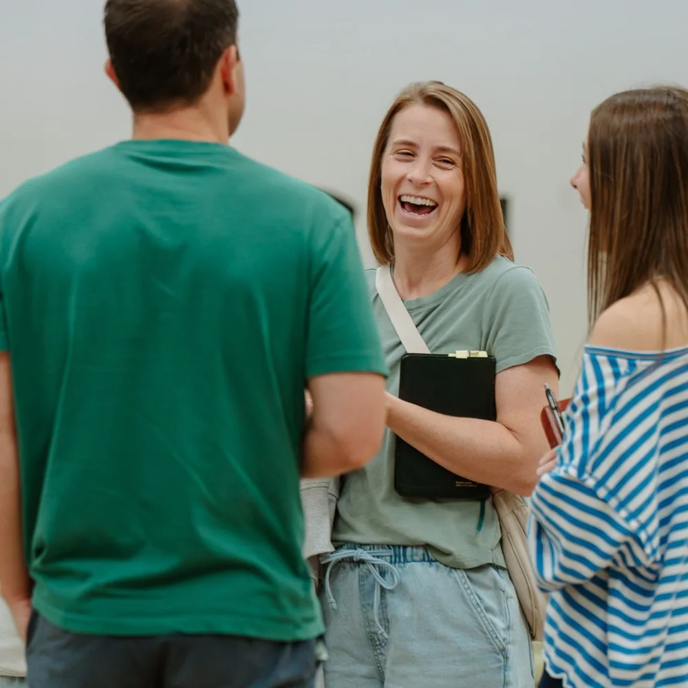 Woman holding her Bible and laughing with friends on a Sunday at Nuvo Church in Dublin, Ohio