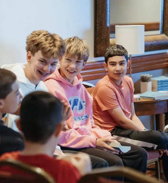 Middle school guys smiling in a small group at Nuvo YTH in Columbus