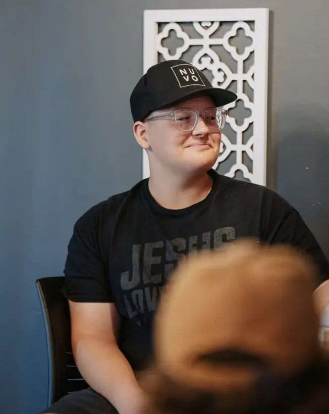 Student in a Nuvo hat smiling during youth group at Nuvo Church in Columbus, Ohio